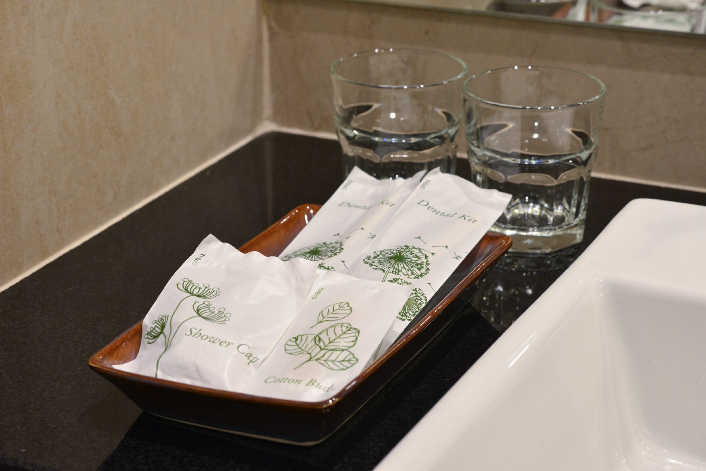 The in-room amenity kit at StayAt Bedever, with shower cap, dental kit and glasses