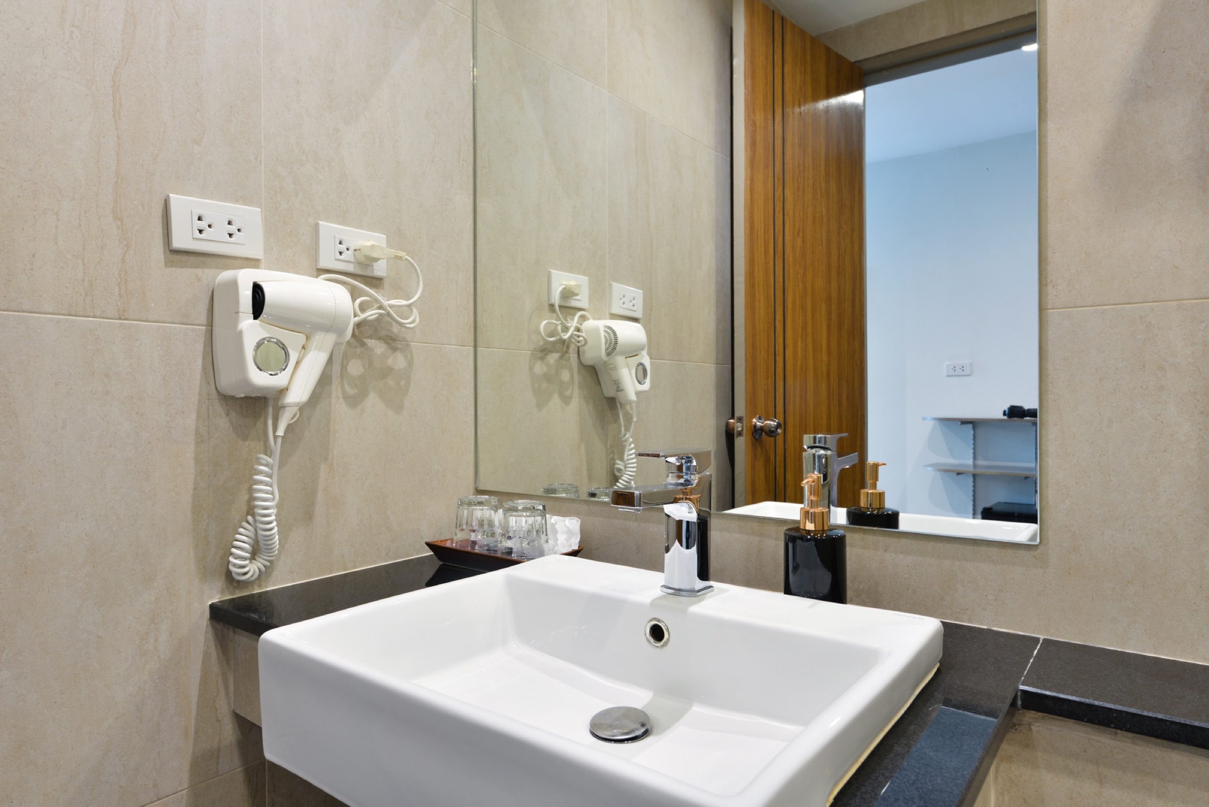 The ensuite bathroom vanity with hairdryer in a Superior King room at StayAt Bedever