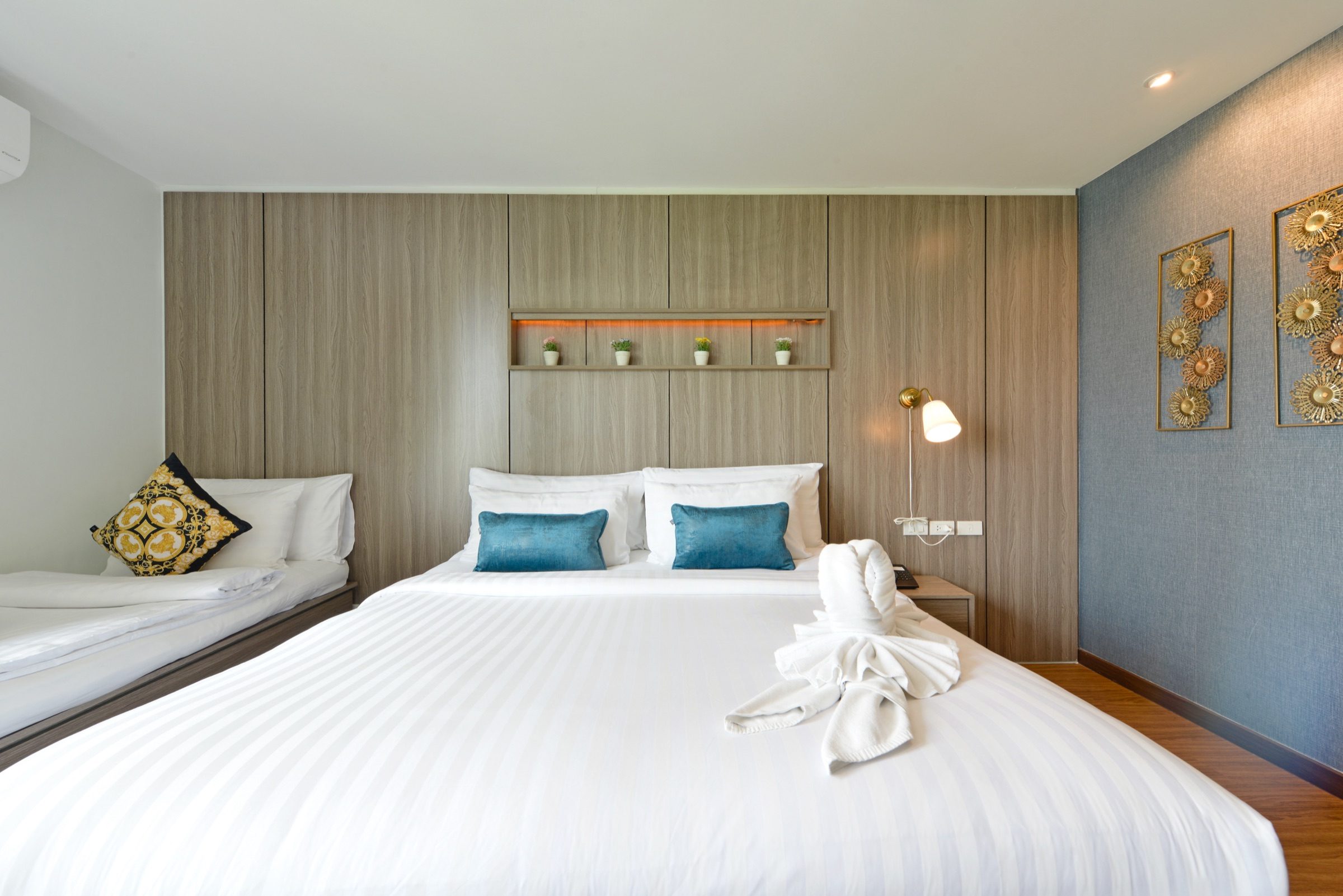 A king bed with an extra single bed added in a Deluxe King room at StayAt Bedever