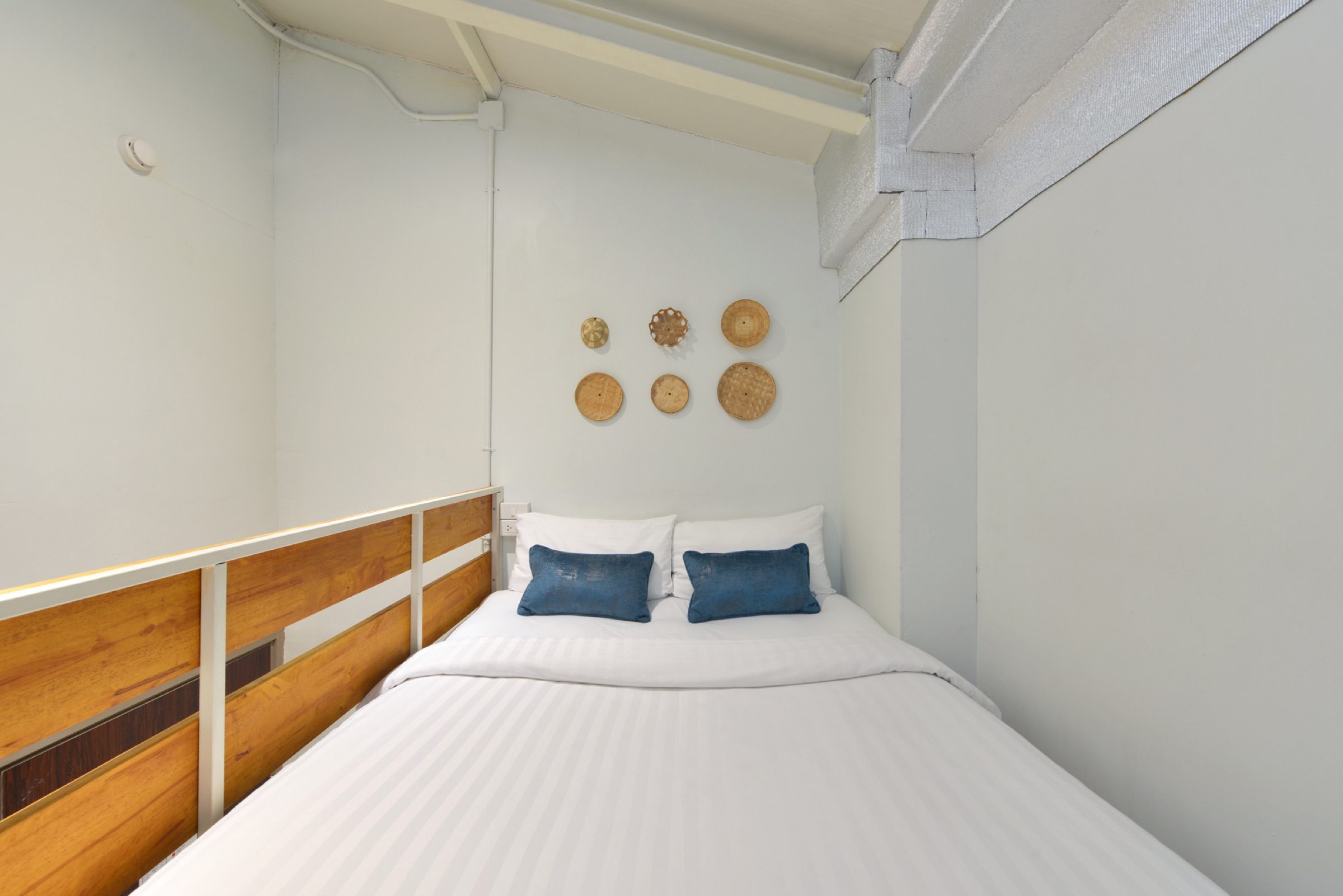 A close view of the queen bed on the Loft Studio sleeping deck at StayAt Bedever