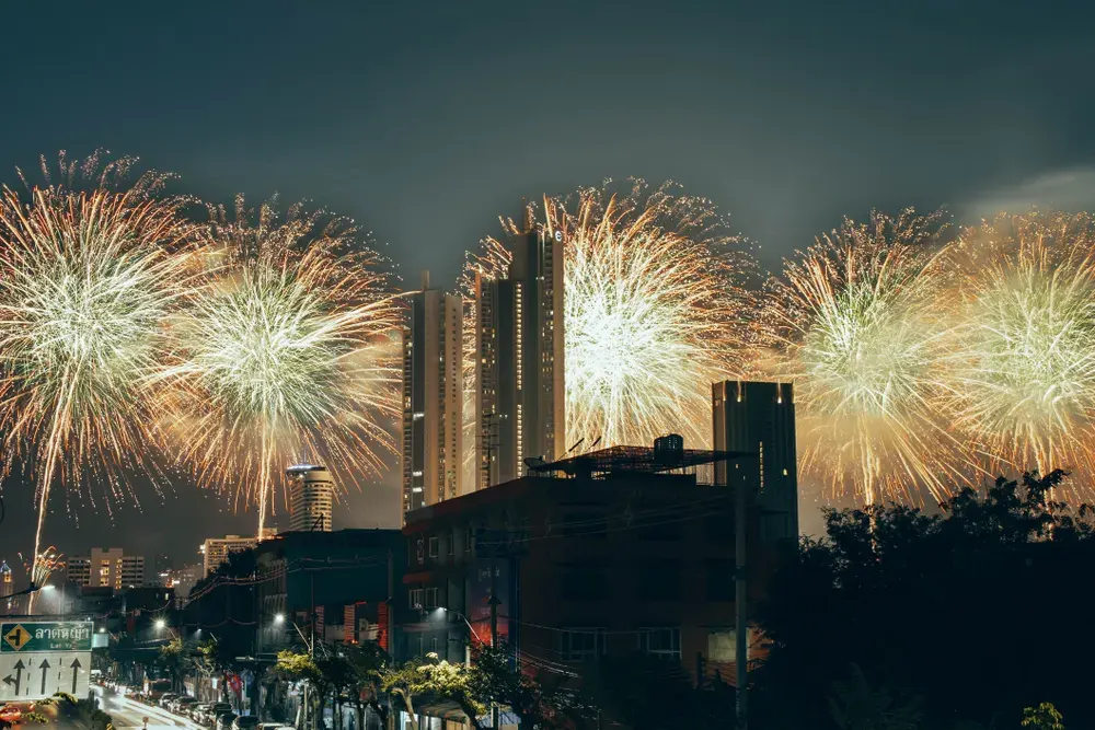 Vibrant fireworks light up the Bangkok skyline, celebrating New Year in Thailand's capital city.