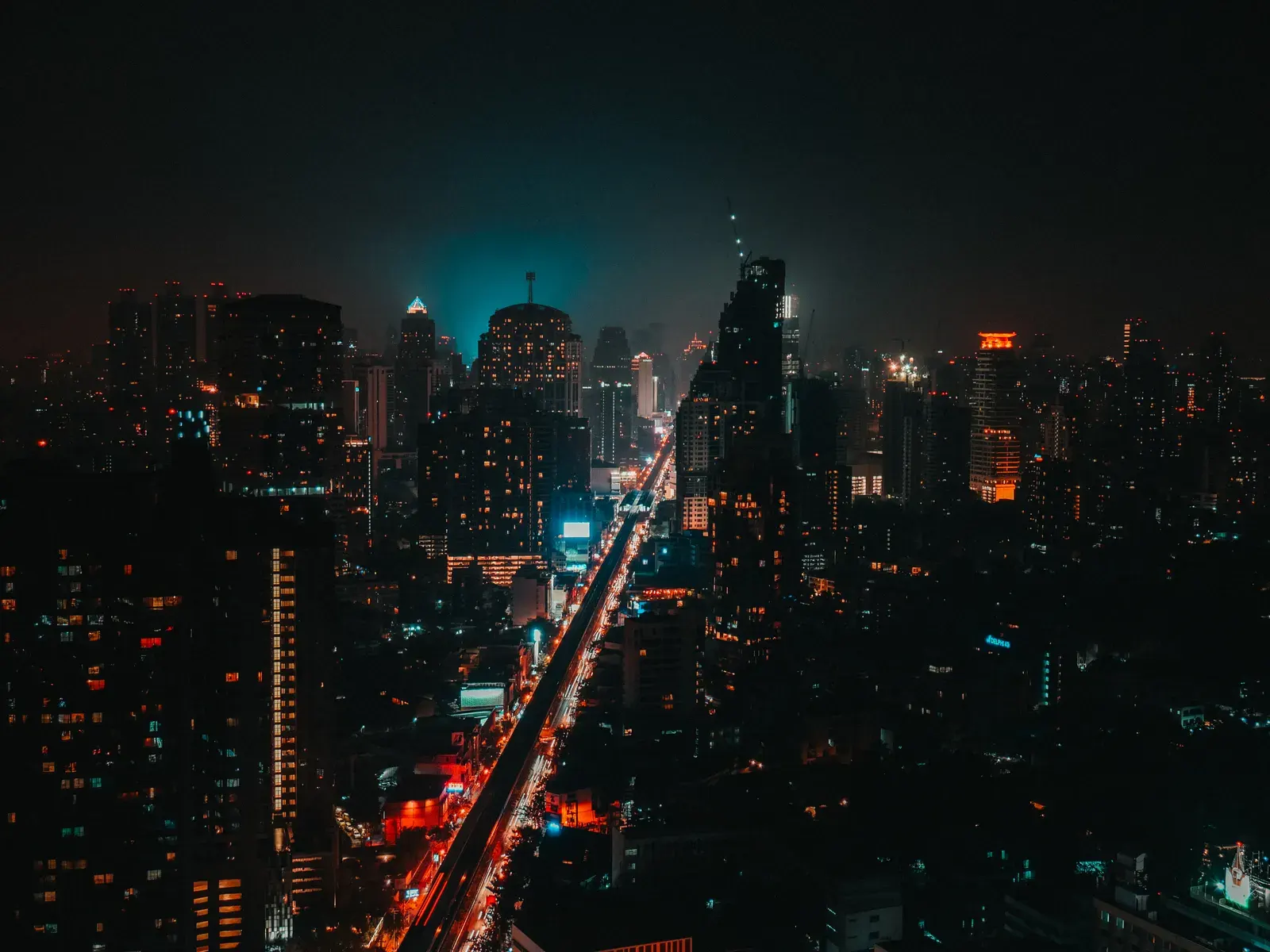A breathtaking view of Bangkok's skyline illuminated at night, showcasing the vibrant urban landscape.
